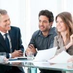 team discussing how to write a meeting summary
